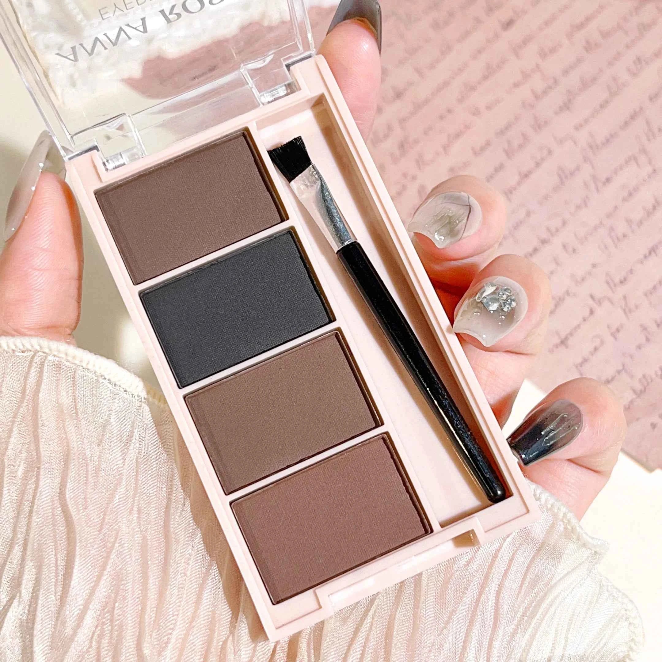 A set of 4-color eyebrow powder trays with brushes in gray and brown matte tones for long-lasting color rendering, filling and s